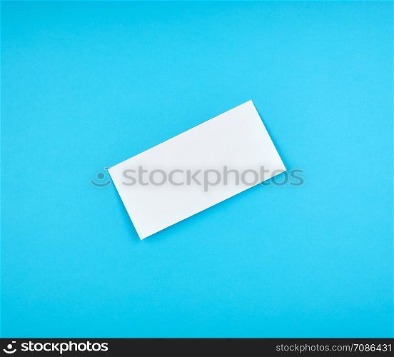 white rectangular paper envelope on a blue background, top view