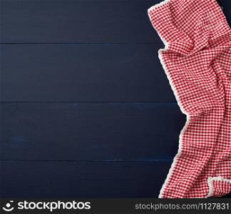 white red checkered kitchen towel on a blue wooden background, picnic background, copy space