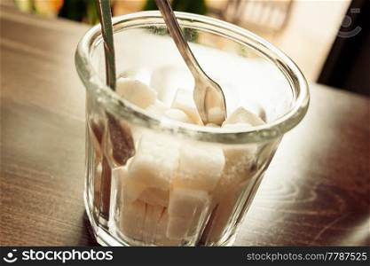 White Refined Sugar Cubes in the sugar-bowl angle view on wooden background. White Refined Sugar Cubes in the sugar-bowl angle view on table