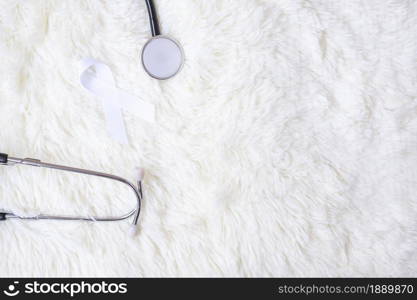 white Ribbon with stethoscope on white color background. November Lung Cancer Awareness month concept
