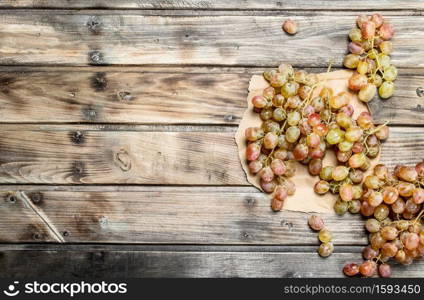 White ripe grapes. On a wooden background.. White ripe grapes.