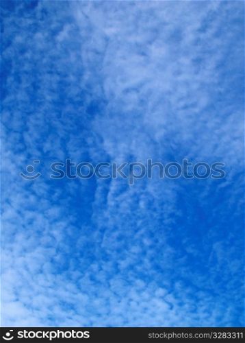 White rippled clouds in blue sky.