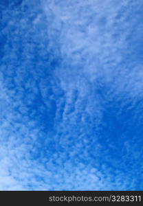 White rippled clouds in blue sky.