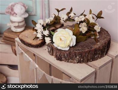 White rose on wooden plate on wooden box.Pink doors,flowers,apple boxes.Great for wedding interior