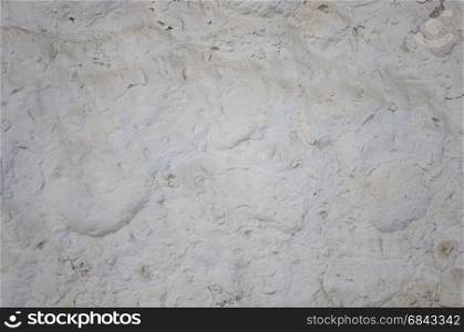 White rough plastered stone wall background with dust