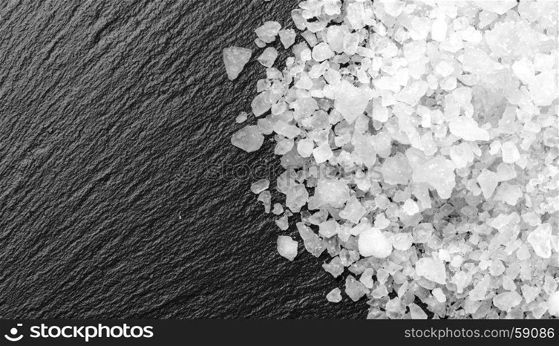 white salt on black background with copy space