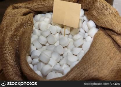 White Salts Pills inside Burlap Sack with Label