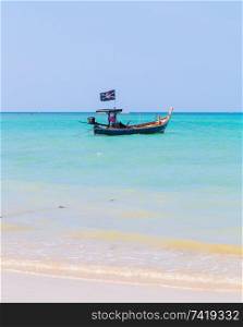 White sand beach and pirate boat in blue sky.. White sand beach and pirate boat in blue sky