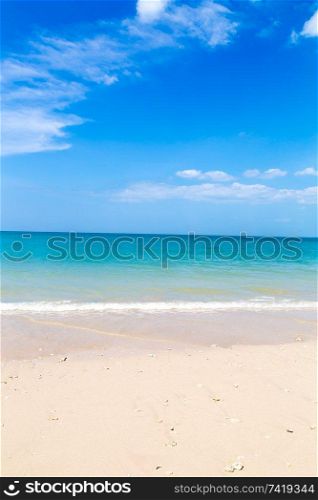 White sand beach and turquoise blue sea under a blue sky.. White sand beach and turquoise blue sea under a blue sky