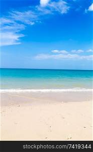 White sand beach and turquoise blue sea under a blue sky.. White sand beach and turquoise blue sea under a blue sky