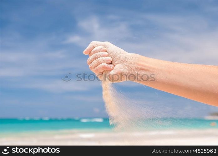 White sand strewing from hand