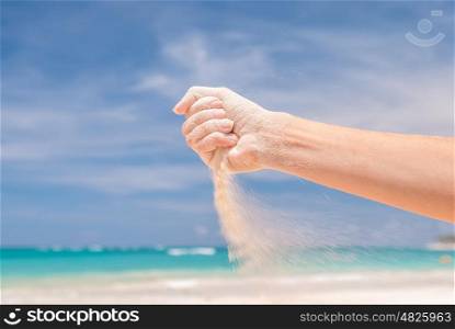 White sand strewing from hand
