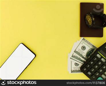 White screen smartphone with a top $ 100 bank note and a yellow background calculator top view