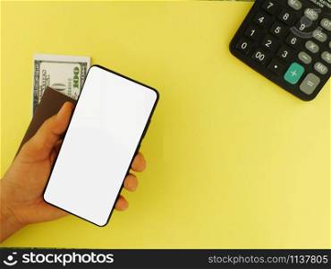 White screen smartphone with a top $ 100 bank note and a yellow background calculator