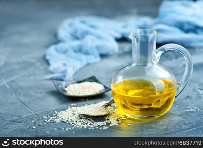 white sesame and oil in glass bottle