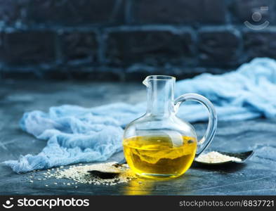 white sesame and oil in glass bottle