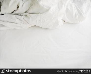White sheets and blankets after use, Wrinkled and disorganized.