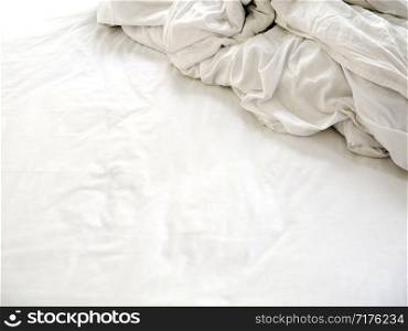 White sheets and blankets after use, Wrinkled and disorganized.