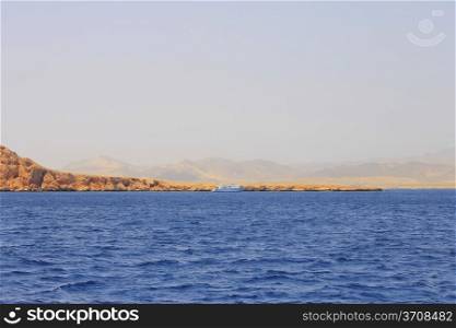 White ship moving by the red sea