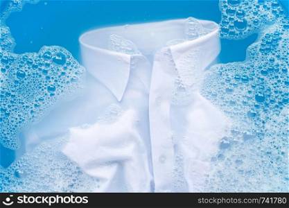 White shirt soak in powder detergent water dissolution, washing cloth. Laundry concept
