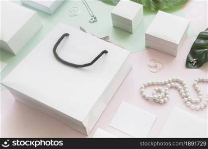 white shopping bag gift boxes with jewelry colored background. Resolution and high quality beautiful photo. white shopping bag gift boxes with jewelry colored background. High quality and resolution beautiful photo concept