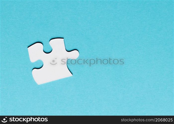 white single puzzle piece blue background