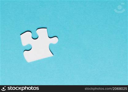 white single puzzle piece blue background