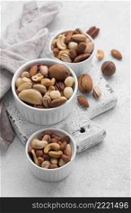 white small bowls filled with assortment nuts high view
