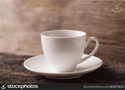 white small ceramic espresso coffee or tea cup on wood background vintage tone