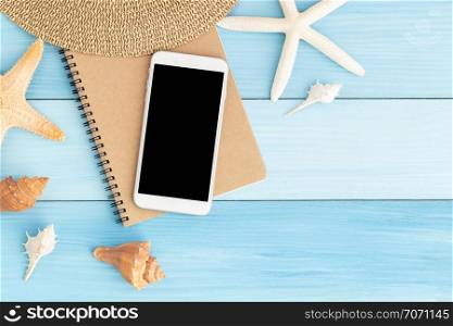 White smartphone on brown notebook on blue wooden floor,Flat lay photo of technology concept in summer