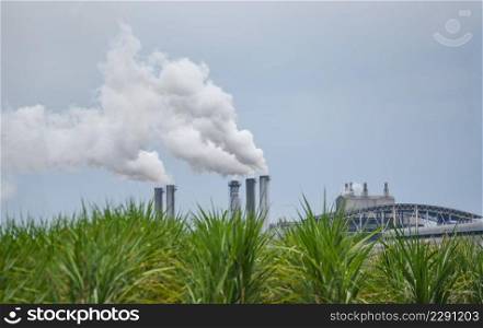 White smoke comes out from smokestacks or exhaust pipes in the factory chimneys emit water vapor which condenses into a whitish cloud before evaporating, Steam sugar factory, electricity generation