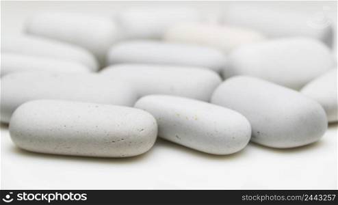 white smooth stones of elongated shape. rounded white stones