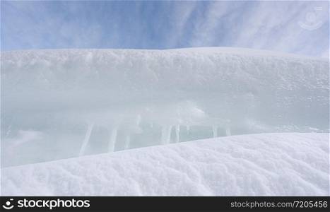 White snow close-up. Snowdrifts and icicles close-up. Frozen snow in a pile. Winter background.