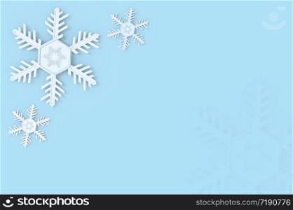 White snowflake decorating on soft blue copy space background.