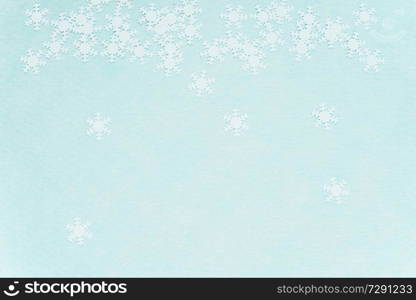 White snowflakes over a turquoise background                               