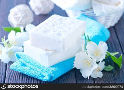 white soap and towels on a table