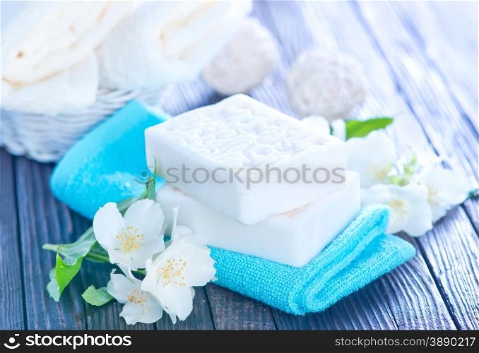 white soap and towels on a table