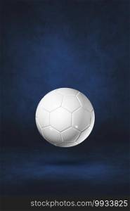 White soccer ball isolated on a dark blue studio background. 3D illustration. White soccer ball on a dark blue studio background