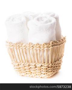 White spa towels in a basket isolated. Spa concept. White towels