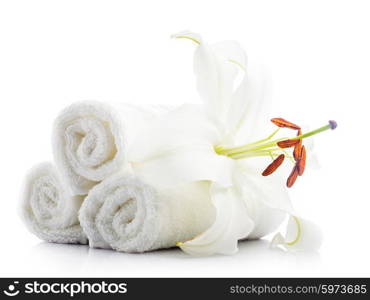 White spa towels with lily flower isolated on white. Spa concept. White towels