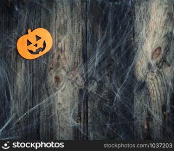 white spider web and carved pumpkin-shaped felt decor, backdrop for Halloween holiday