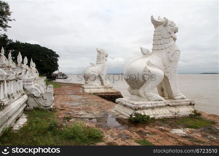White statues big lion on the bank of river in Mingun, Myanmar