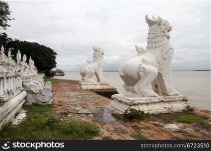 White statues big lion on the bank of river in Mingun, Myanmar
