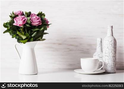White still life with roses and cup. White still life