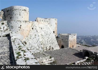 White stone castle Krak de Chevalier in Syria