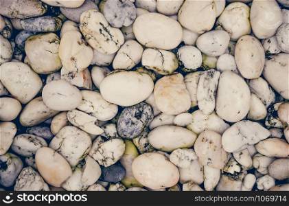 White stone pebble texture background on ground decorate in the garden