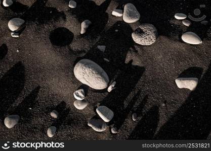 White stones on black sand
