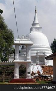 White stupa and bell tower in Sapugoda temple in Beruwala, Sri Lanka