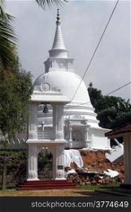 White stupa and bell tower in Sapugoda viharaya in Beruwala, Sri Lanka