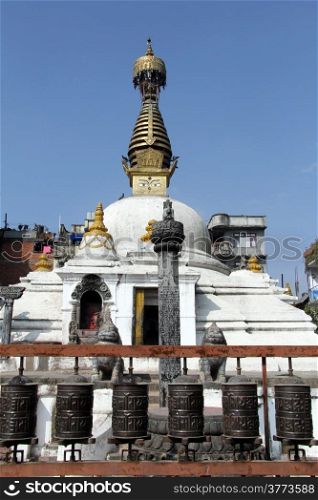 White stupa and bronze drums in Patan, Nepal